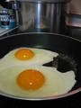  eggs frying in pan 