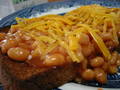  closeup of beans on toast with salt and pepper 